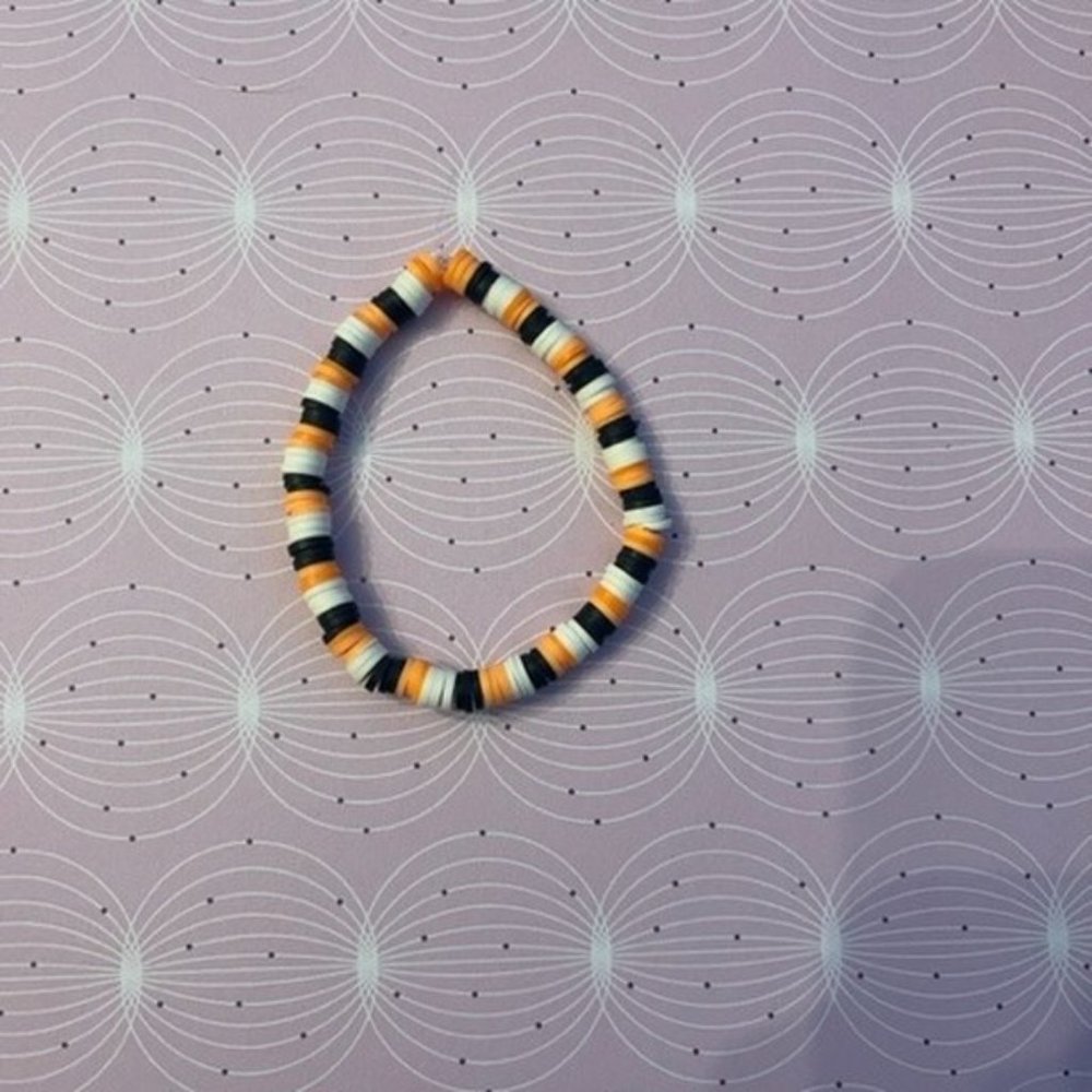 Black, orange, and white bracelet